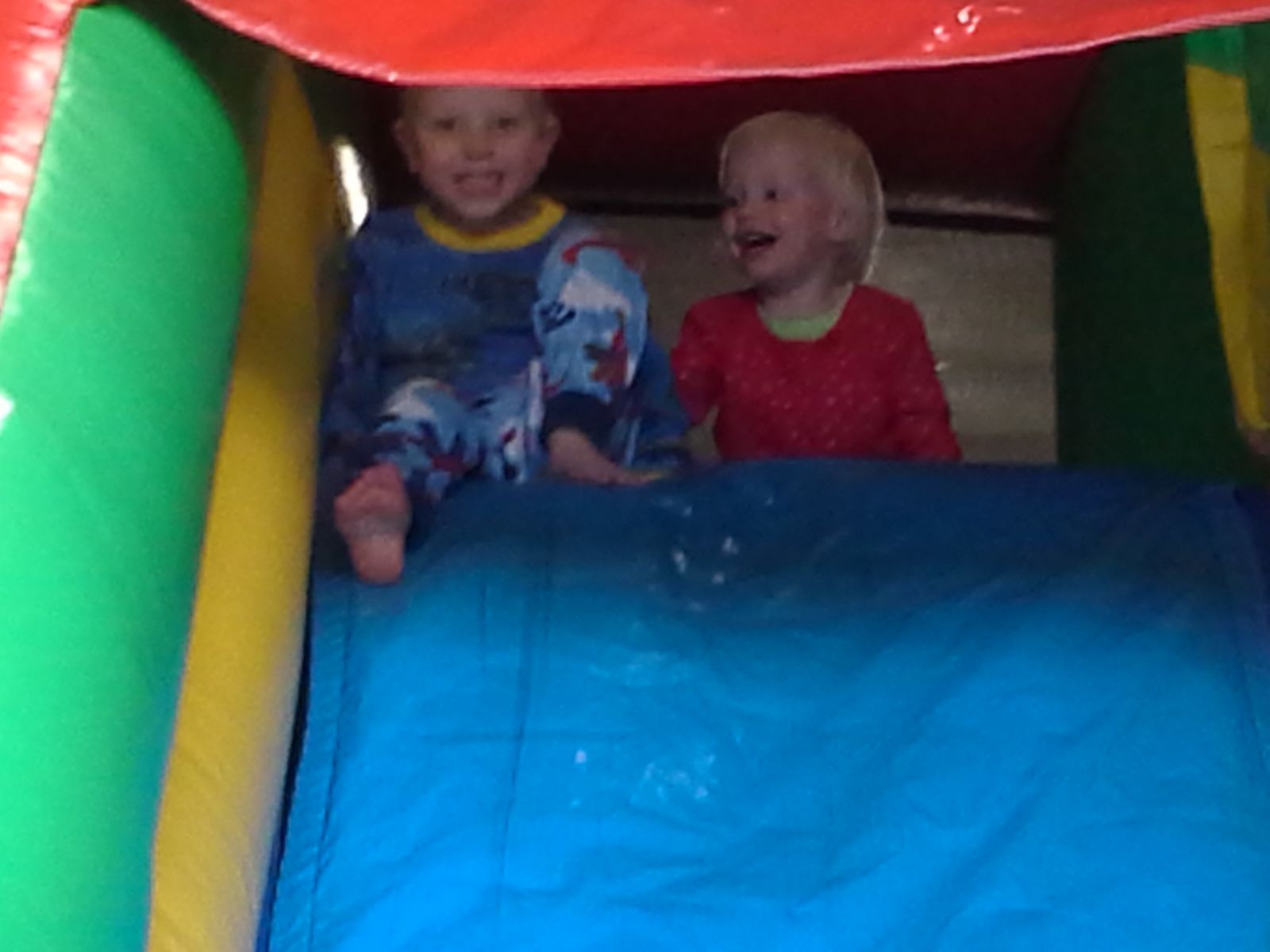 2 Kids at the top of the slide in a Castle Combo Inflatable